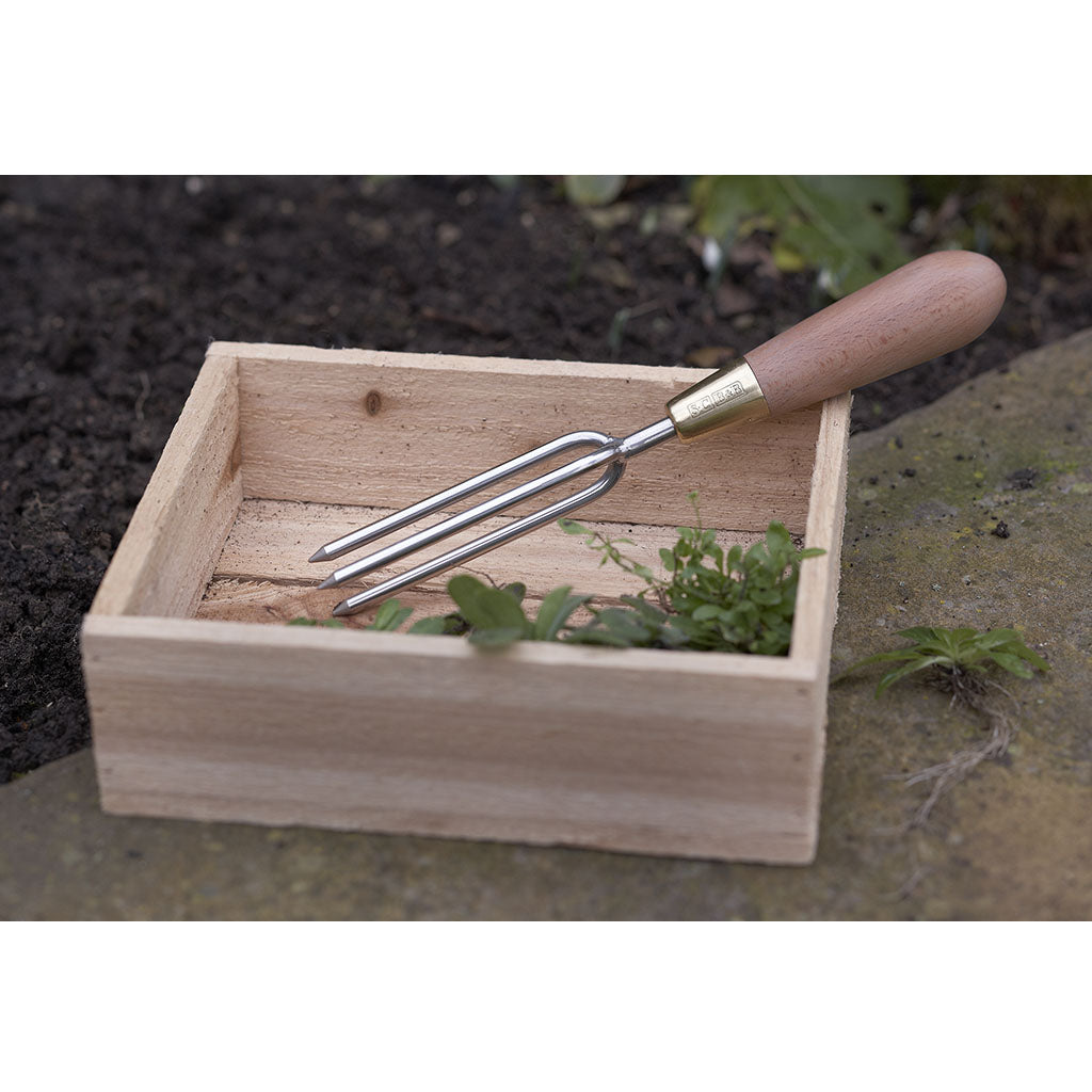 Sophie Conran Weeder by Burgon & Ball in garden