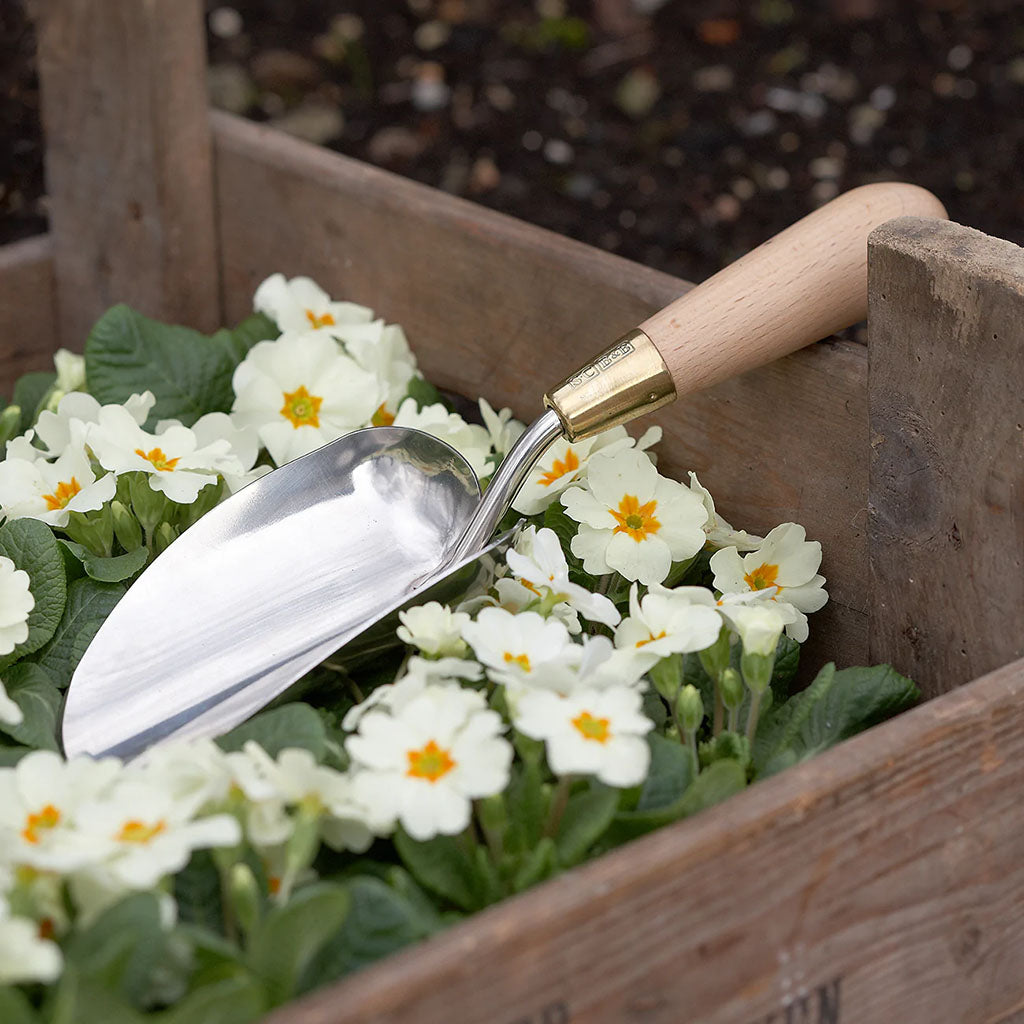 Sophie Conran Garden Trowel by Burgon & Ball sitting in flowers