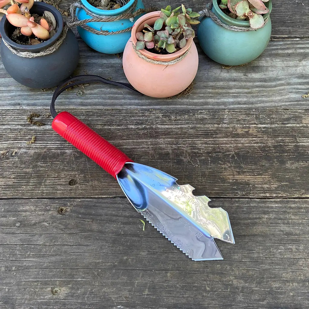 Multi-Crop Garden Trowel by Wilcox on garden table