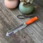9" Serrated Gator Digging Trowel by Wilcox on garden table